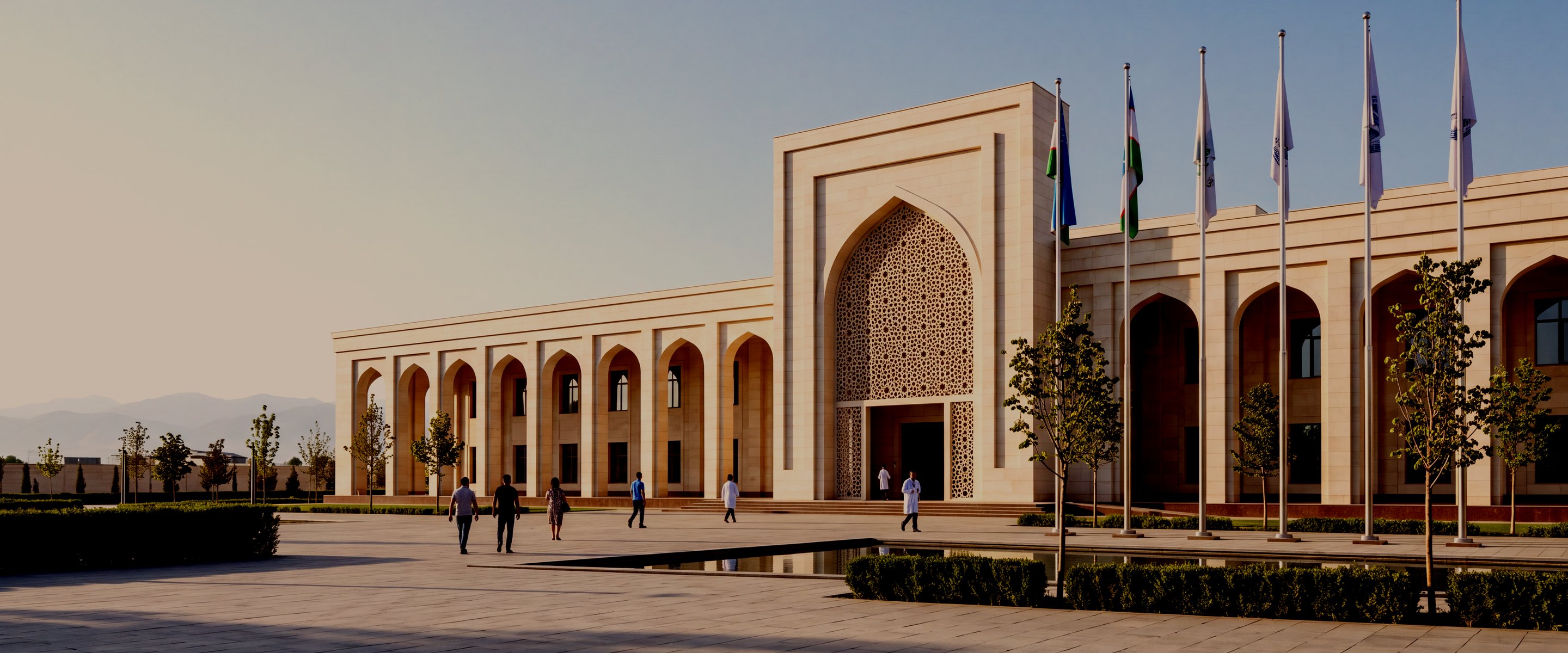 The main entrance forecourt of Fergana International Hospital, with flagpoles flying the flag of Uzbekistan
